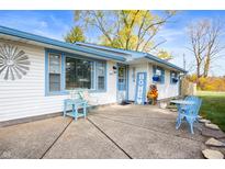 Cute ranch home with blue accents, welcoming porch, and patio furniture at 4153 Allen Dr, Brownsburg, IN 46112