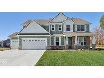 Two-story house with green siding, white accents, and a three-car garage at 360 N Windswept Rd, Greenfield, IN 46140