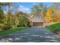 Brick house with a two-car garage and landscaped yard at 6902 Creekridge Trl, Indianapolis, IN 46256