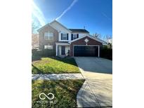 Brick two-story house with a two-car garage and landscaped lawn at 10321 Gladeview Dr, Indianapolis, IN 46239