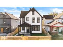 Renovated two-story house with a new fence and landscaping at 631 Cottage Ave, Indianapolis, IN 46203
