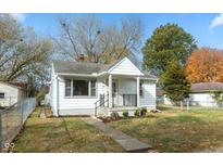 White house with a green lawn and black fence at 418 N 24Th Ave, Beech Grove, IN 46107