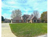 Brick two-story home with landscaped lawn and attached garage at 2413 Griton Ct, Shelbyville, IN 46176