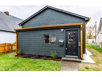 Charming dark gray home with copper gutters and well-manicured lawn at 1621 Draper St, Indianapolis, IN 46203