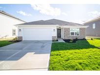 Brick ranch home with a white garage door and landscaped lawn at 1147 Fleming Dr, Greenfield, IN 46140