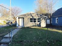 Charming gray house with a well-maintained lawn and chain link fence at 1601 Draper St, Indianapolis, IN 46203
