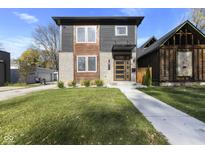 Modern two-story home with gray and wood siding, landscaping, and a walkway at 1514 E 12Th St, Indianapolis, IN 46201
