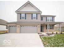 Two-story house with gray siding, brick accents, and a three-car garage at 259 Lar Lan Dr, Danville, IN 46122