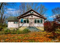 Charming ranch home with stone steps and fall leaves at 3136 E Edgewood Ave, Indianapolis, IN 46227