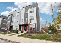Modern three-story townhome with gray and white siding, red door, and landscaping at 1014 Sterling St, Indianapolis, IN 46201