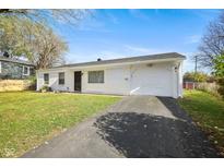 White ranch house with a one car garage and a well-manicured lawn at 3623 Chateau Ln, Indianapolis, IN 46226