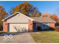 Brick ranch home with attached garage and autumn trees at 304 Chestnut St, Danville, IN 46122