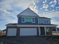 Two-story home with gray siding, brick accents, and a two-car garage at 6143 Madera Dr, Whitestown, IN 46075