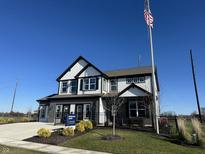 Two-story home with white siding, black accents, and a landscaped yard at 6435 Forest Brook Dr, Indianapolis, IN 46259