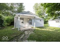 Cute ranch home with covered porch and stone pathway at 1519 E Mills Ave, Indianapolis, IN 46227