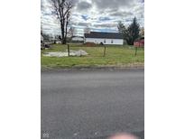 Empty lot with a new home under construction and chain link fence at 879 E Gray St, Martinsville, IN 46151