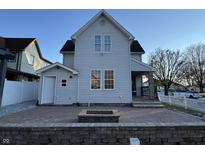 Two-story house with a patio, fire pit, and fenced yard at 803 E 21St St, Anderson, IN 46016