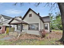 Charming bungalow exterior, featuring a front porch and well-maintained landscaping at 412 N Emerson Ave, Indianapolis, IN 46219
