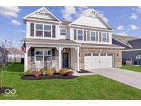 Brick two-story home with a large front porch and two-car garage at 1706 Crossley St, Fortville, IN 46040