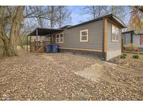 Gray mobile home with covered porch and landscaping at 71 E Cove Ct, Cicero, IN 46034