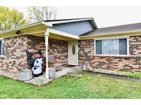 Brick ranch house with a covered porch and well-maintained lawn at 7922 S Sherman Dr, Indianapolis, IN 46237