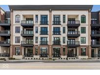 Modern brick building with multiple balconies and street-level entrances at 41 N Rangeline Rd # 7, Carmel, IN 46032