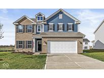 Two-story home with brick and blue siding, a white garage door, and a landscaped lawn at 1782 N Clearwater Dr, Greenfield, IN 46140