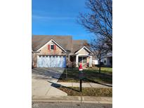 Brick ranch home with two-car garage and landscaped yard at 4835 Franklin Villas Dr, Indianapolis, IN 46237