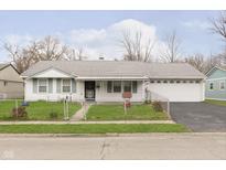 Ranch home with attached garage and fenced yard at 8530 Meadowlark Dr, Indianapolis, IN 46226