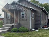Charming house with gray siding, stone accents, and a welcoming front porch at 306 E Cherry St, Advance, IN 46102