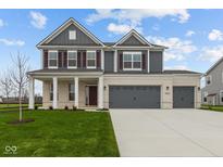 Two-story house with gray siding, brick accents, and a three-car garage at 4973 Amber Crest Dr, Brownsburg, IN 46112