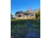 Ranch house with stone facade, landscaping, and a driveway at 3128 13Th St, Columbus, IN 47201
