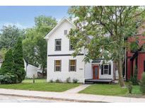 Charming two-story home with a red door and landscaped yard at 1306 S Talbott St, Indianapolis, IN 46225