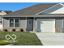 Gray ranch home with white garage door and landscaping at 1432 Coen Ct, Columbus, IN 47201