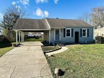 Charming ranch home with carport and landscaped lawn at 1714 S Goodlet Ave, Indianapolis, IN 46241