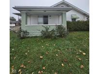 Charming bungalow with a covered porch and well-maintained lawn at 1401 Albany St, Beech Grove, IN 46107