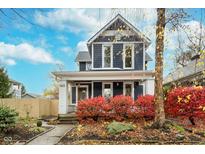 Charming two-story home with a gray exterior and red landscaping at 1423 Hoyt Ave, Indianapolis, IN 46203