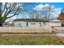 Cute ranch home with a white picket fence and detached garage at 8902 Carla Dr, Indianapolis, IN 46219