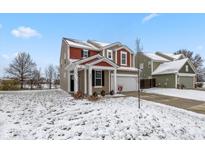 Two-story house with a snow-covered lawn, red and brown accents at 6624 Timberline Trl, Whitestown, IN 46075