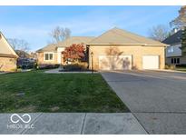 Brick house with 3-car garage, manicured lawn, and mature trees at 12954 Water Ridge Dr, Fishers, IN 46055