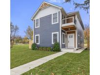 Two-story house with gray siding, white accents, and a front walkway at 1519 N Beville Ave, Indianapolis, IN 46201
