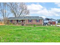 Brick ranch house with large yard, detached garage, and covered patio at 16371 State Road 38 E, Noblesville, IN 46060