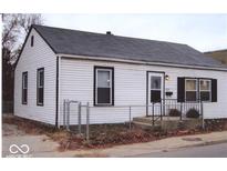 White house with black trim, gray roof, and a chain link fence at 3726 N Emerson Ne Ave, Indianapolis, IN 46218