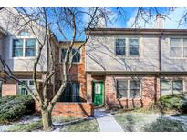 Brick front townhouse with green door, walkway, and landscaping at 9464 Maple Way # 27, Indianapolis, IN 46268