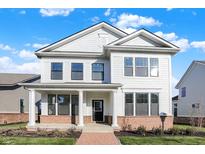 Two-story white house with brick base, porch, and walkway at 1436 Lake Haven Ln, Westfield, IN 46074