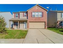 Charming two-story brick home with attached garage and driveway at 10938 Delphi Dr, Camby, IN 46113