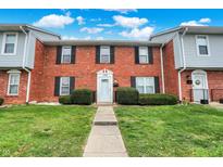 Brick front exterior of a townhome with well-manicured lawn at 1709 Queensbridge Dr, Indianapolis, IN 46219