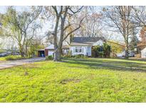 Ranch home with large front yard, mature trees, and detached garage at 80 S Mickley Ave, Indianapolis, IN 46241