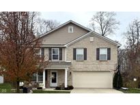 Two-story brick home with a neutral color palette and a well-maintained lawn at 10048 New Dawn Pl, Avon, IN 46123