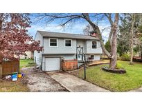 Charming house with a gray exterior, attached garage, and landscaped yard at 1124 Commission Rd, Greenwood, IN 46142